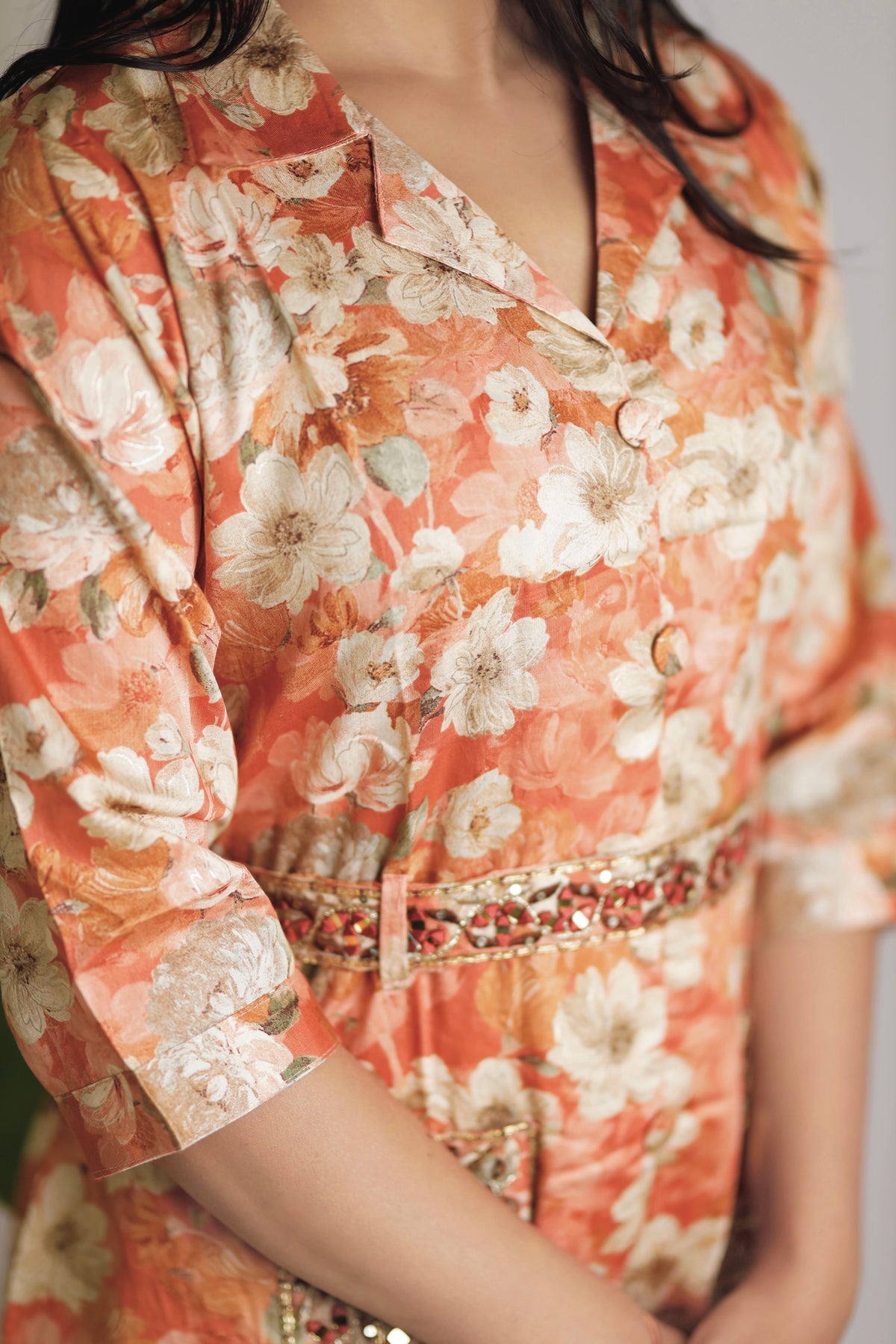 Orange floral co-ord set with ethnic belt.